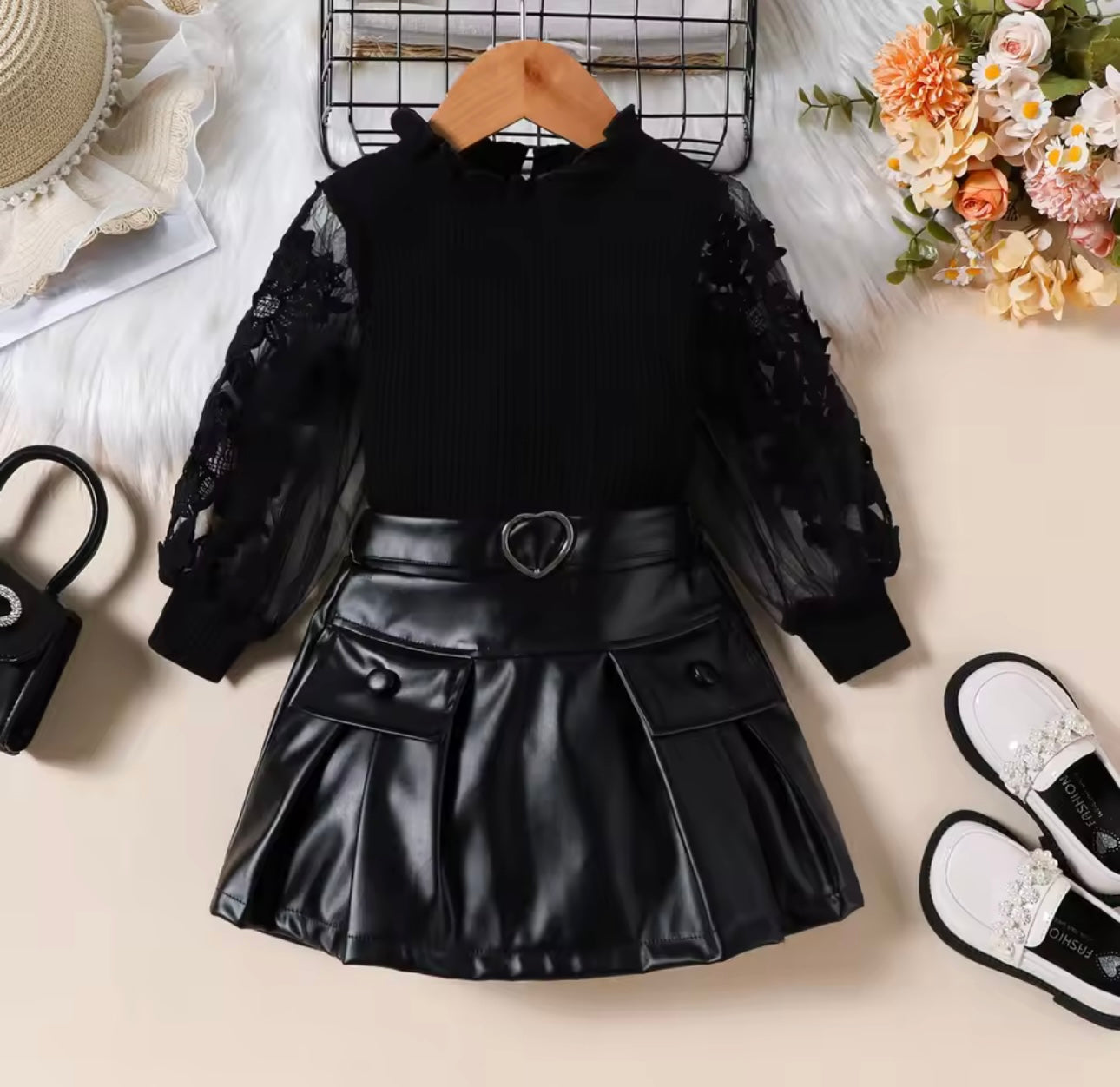 Black ribbed top , net embroidered sleeve with leather skirt